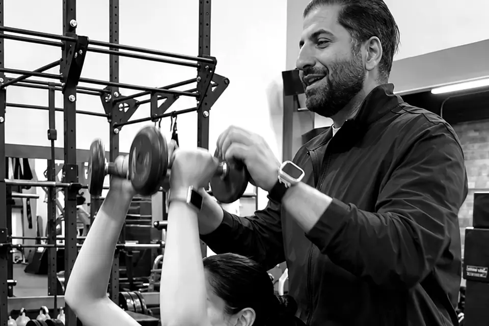 Shayan spotting a client on an incline dumbbell press